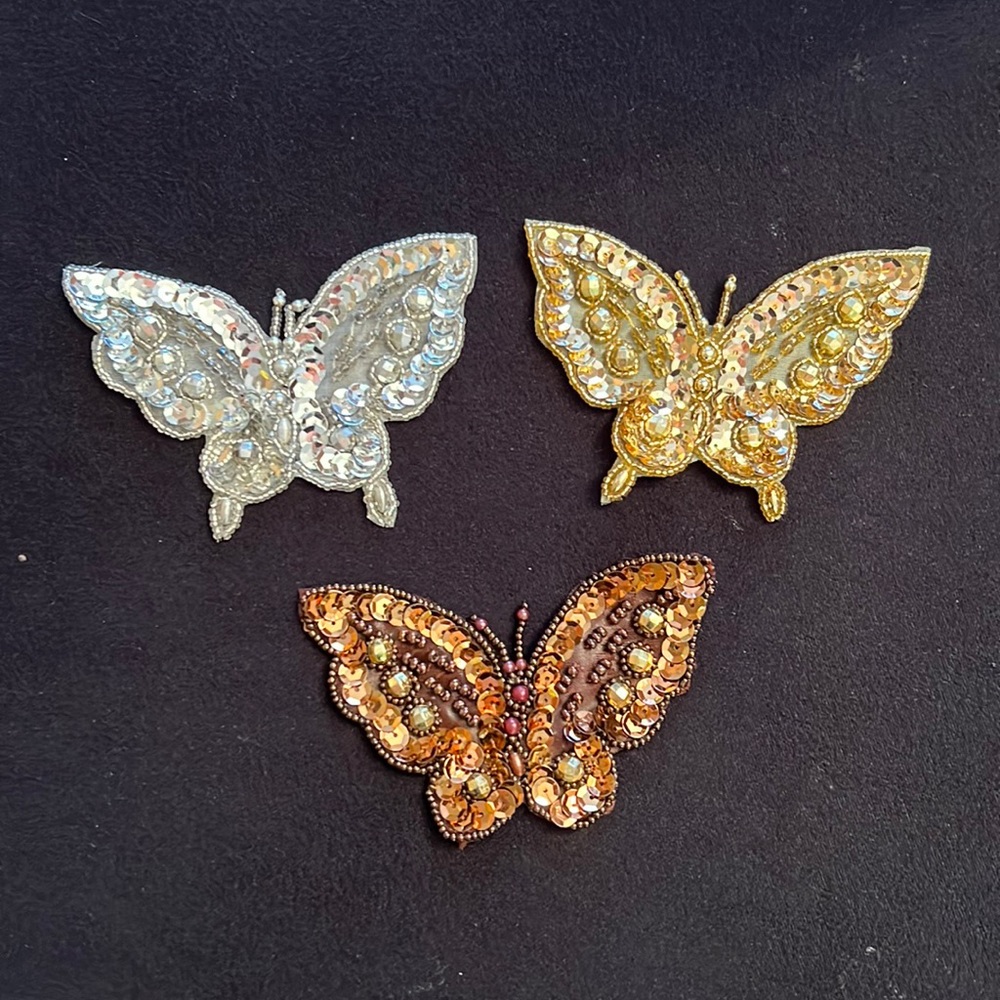 Sequin butterflies in gold, silver, bronze. 4” x 3”. Sew on clothing.